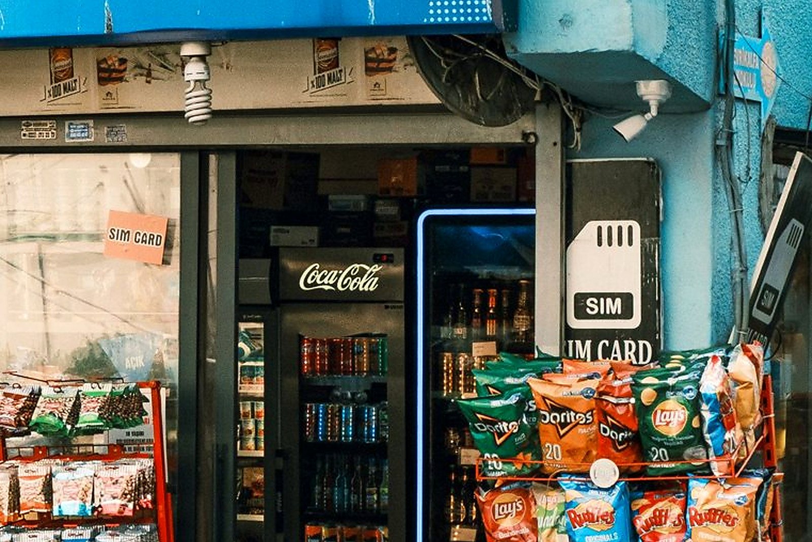 Free A vibrant display of snacks and SIM cards at a local convenience store entrance. Stock Photo